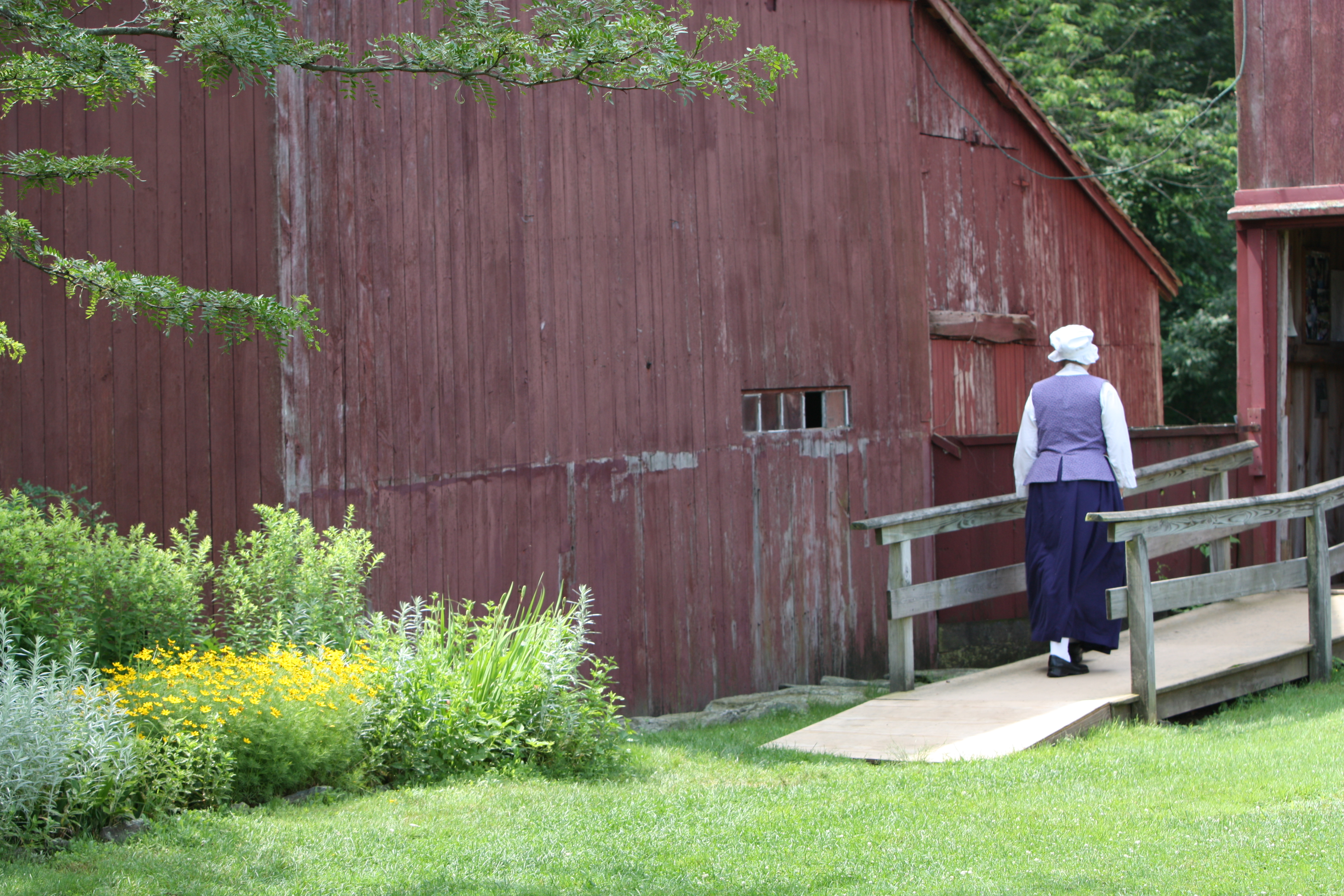 Woman walking by old building