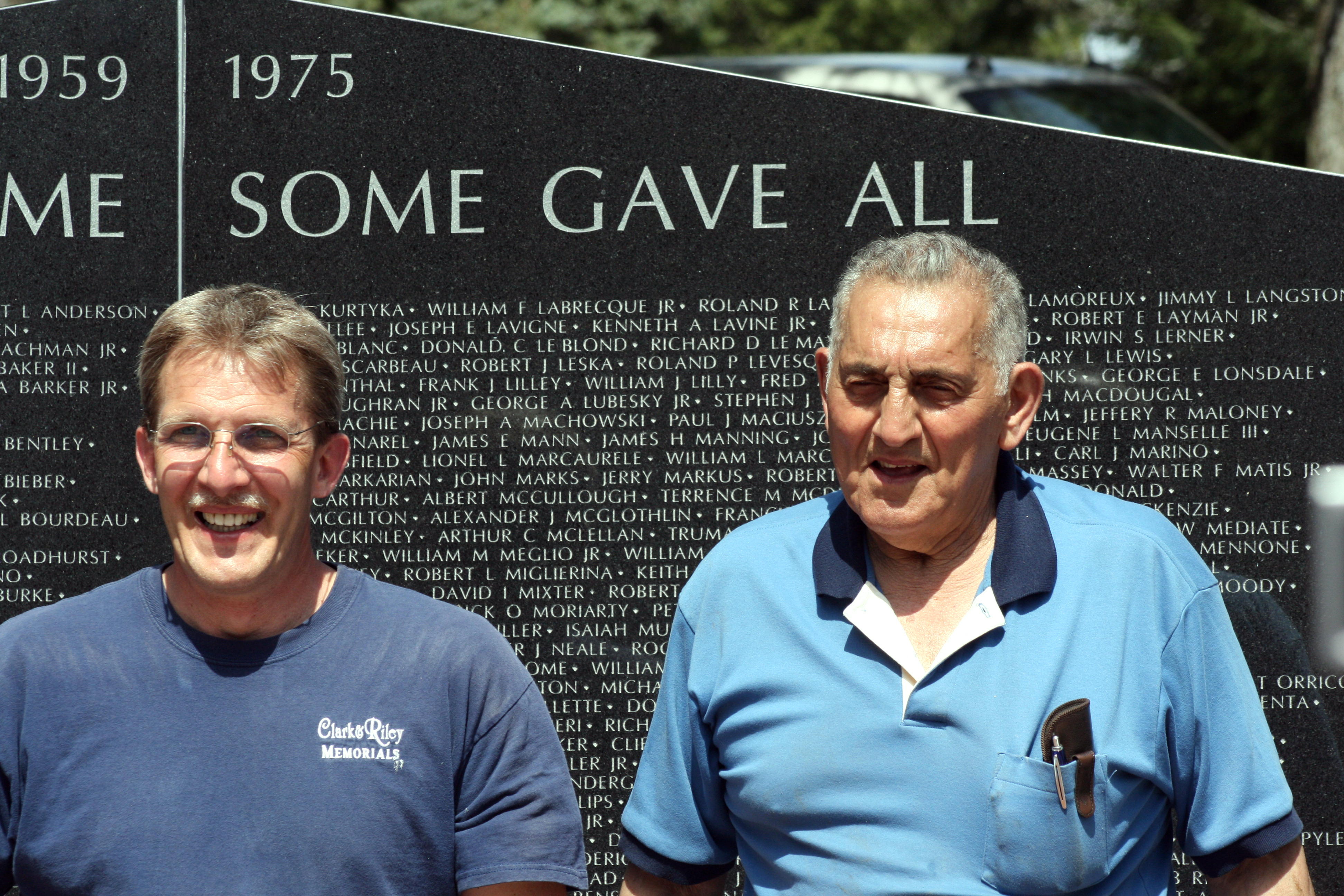 Men in front of memorial